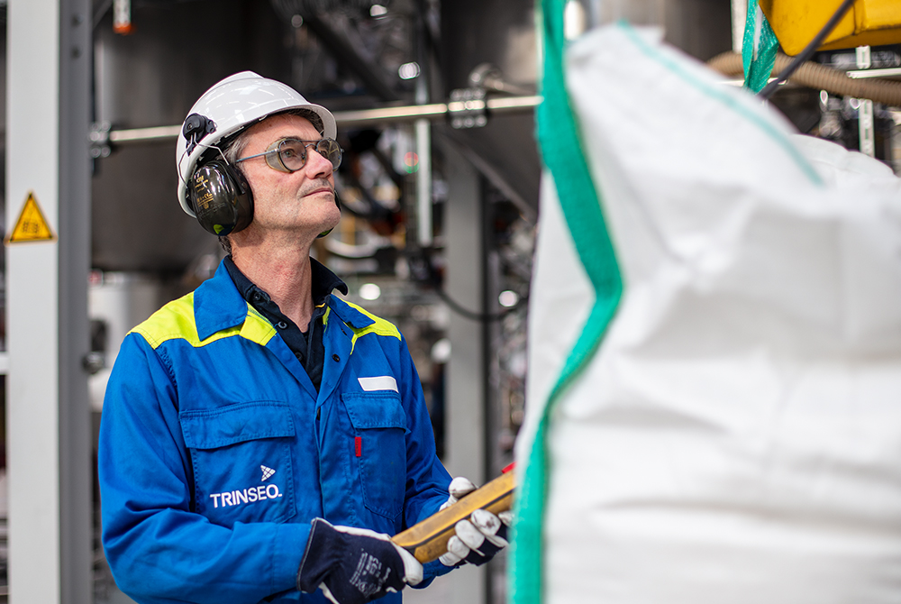 A man wearing safety equipment working in a plant